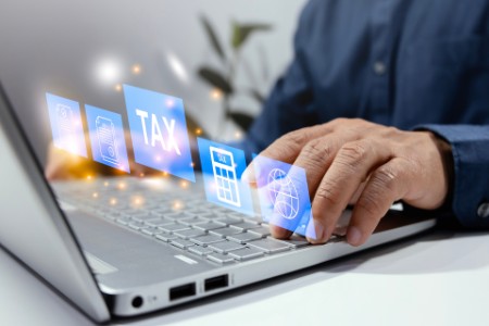 Businessman using tablet to display tax form online personal income tax return for tax payment