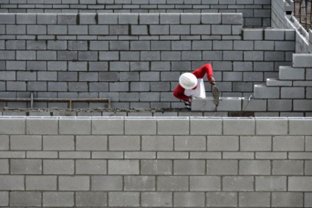 Brick lawyer working on brick wall