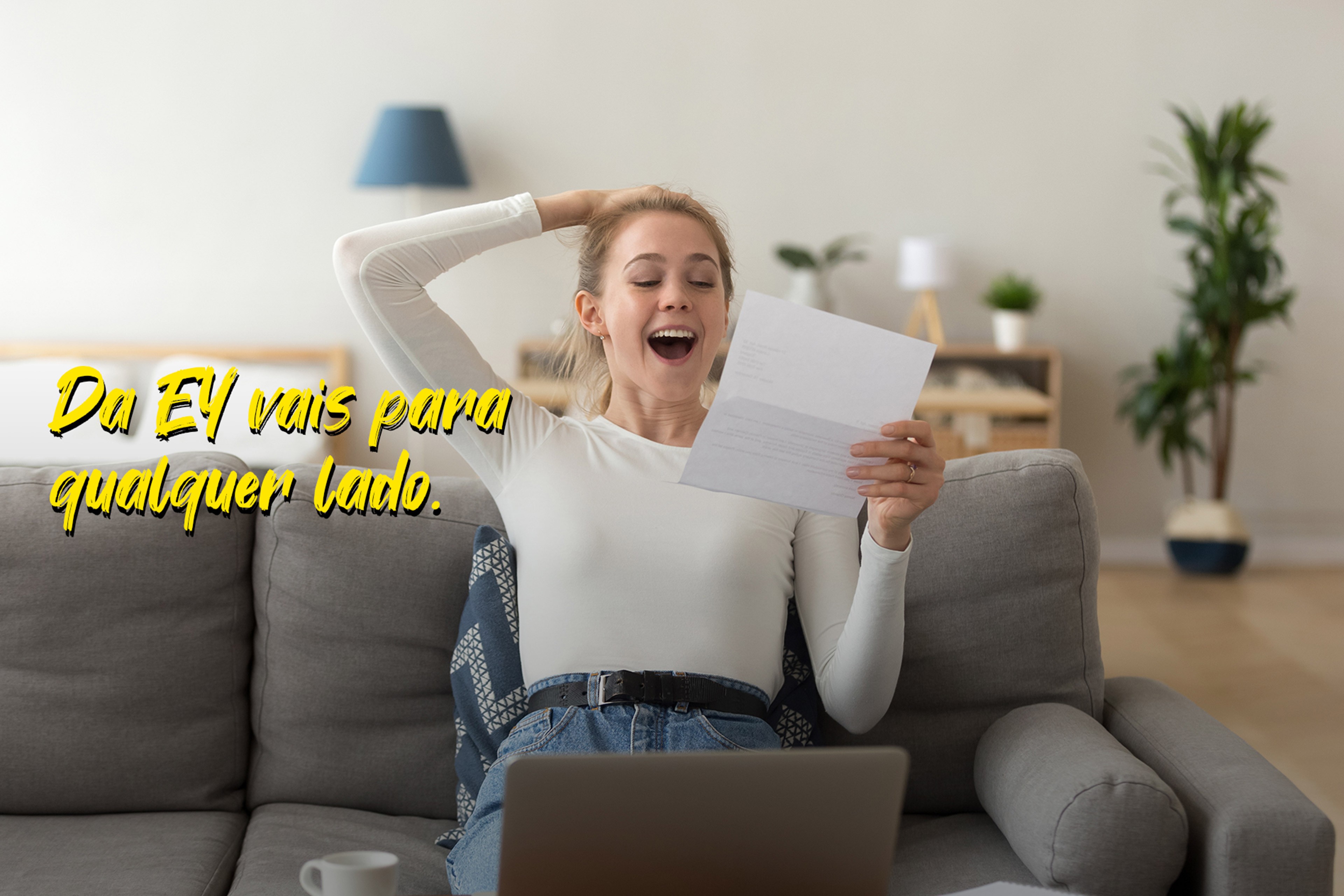 EY woman laughing while holding a letter