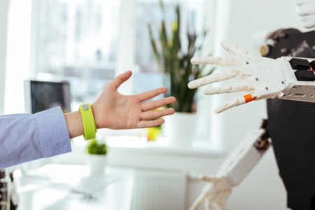 EY human and robot connecting hands