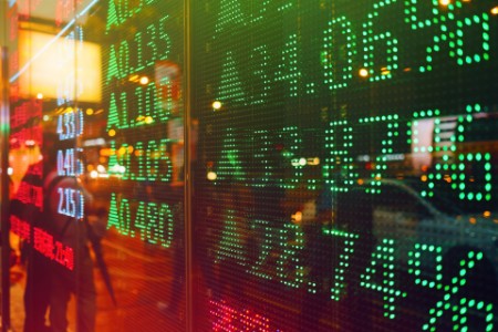 Stock exchange market display screen board on the street showing stock rises in green colour
