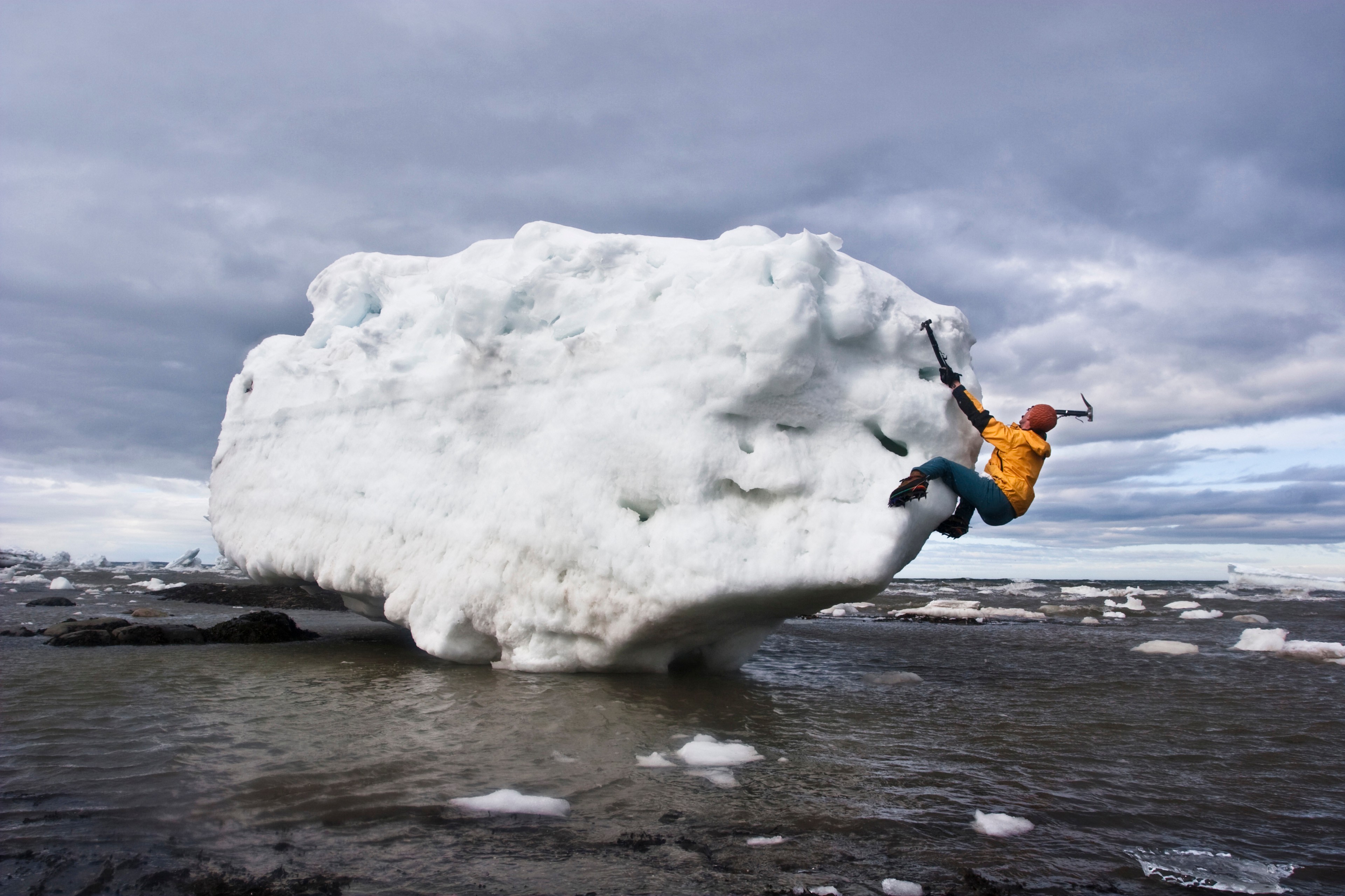 Person ice bouldering on iceberg