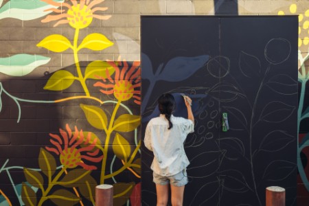 Young women doing mural art