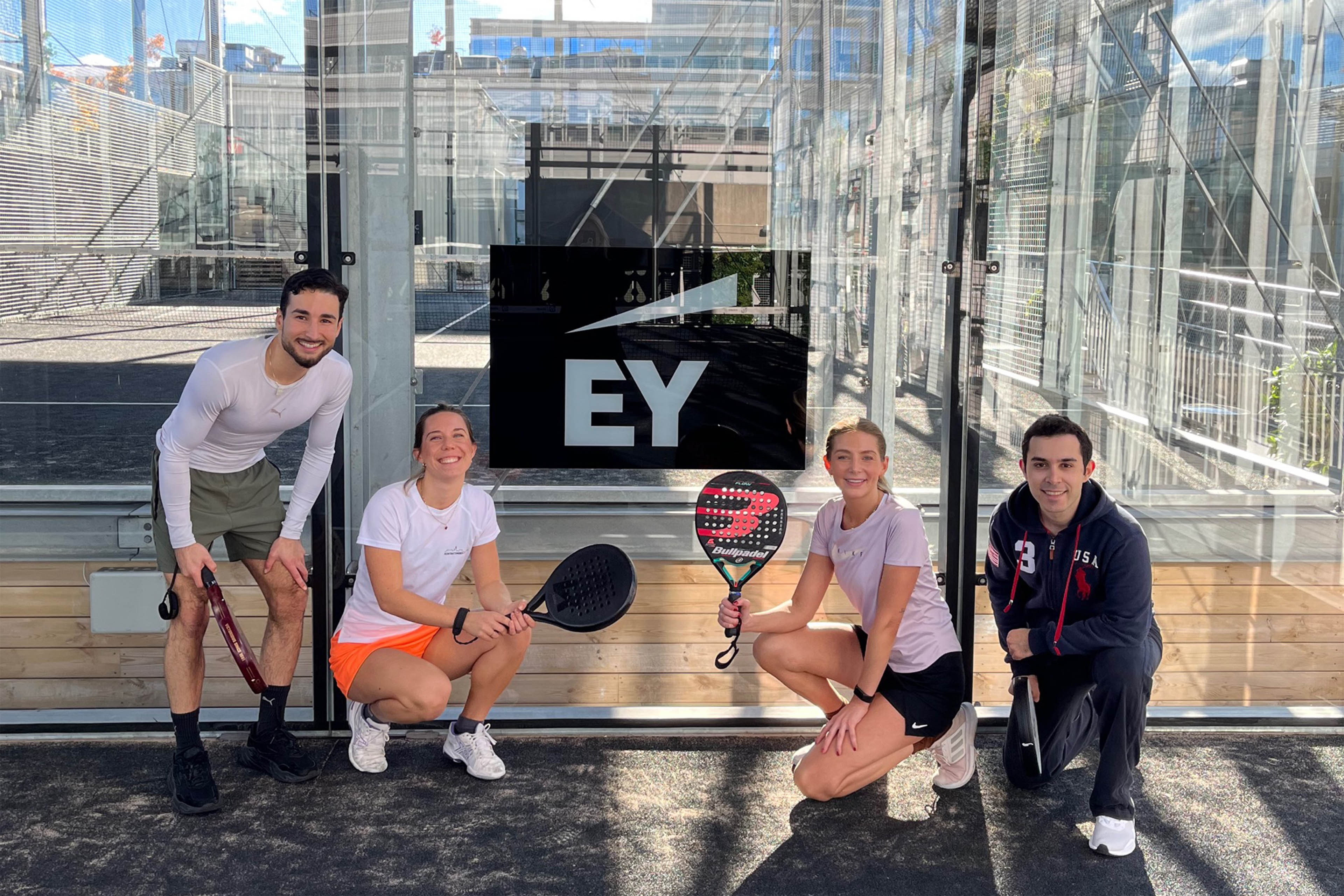 EY business people playing padel during the lunch breaks